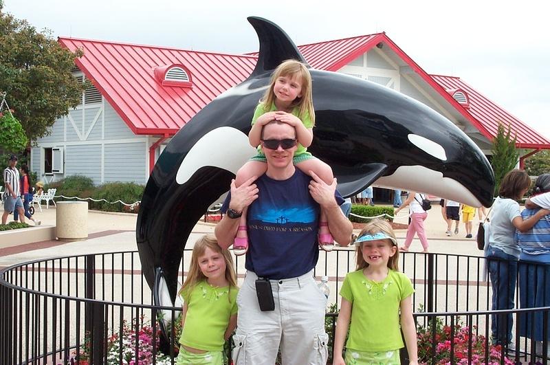 Alan and the girls standing in front of the only whale that would hold still for a photo