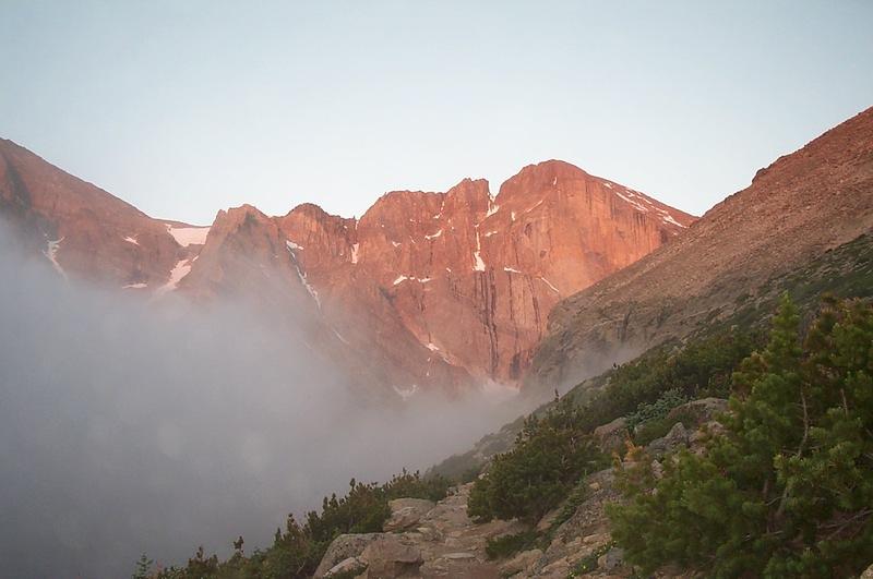 Long's emerging from the clouds as the sun comes up.