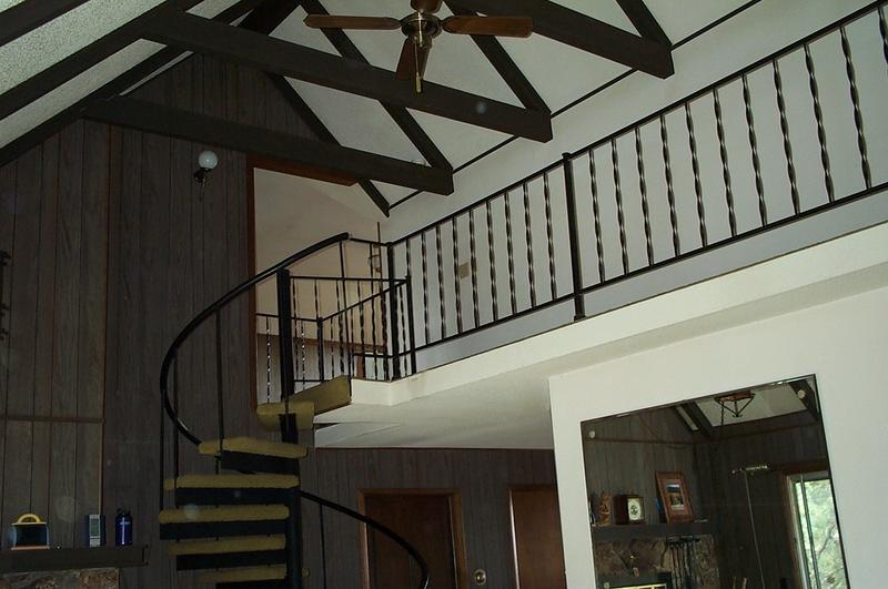 The landing, wonderful 70's beams and spiral staircase (with green carpet)