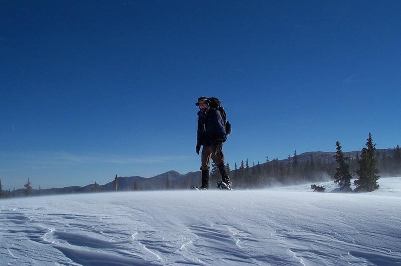 Alan standing on a HUGE hardpacked snow drift on our way back down the trail