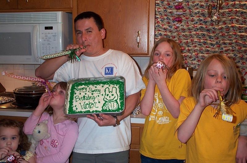 Victor and the girls with the cake.