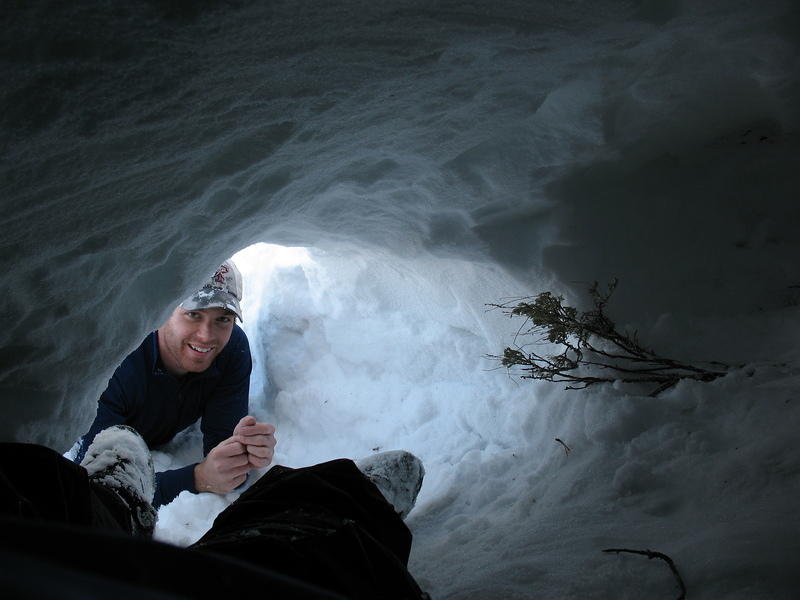 Michael peeks in through the entrance to the snow cave.