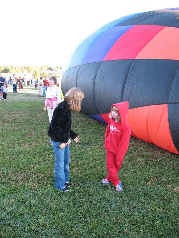 Stand by the balloon so I can take a picture please