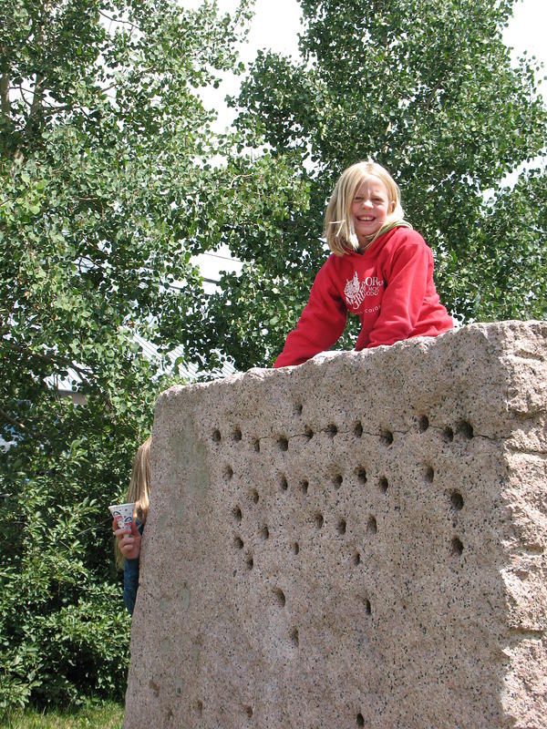 Hannah sits on a rock at the Hard Rock Park, I still don't know what the holes mean