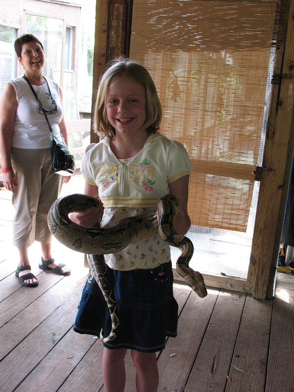 Carolyn laughs as Hannah tries look nonchalant about holding the snake