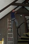 alan working on the ceiling beams in his climbing harness